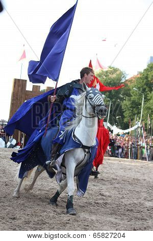 Riga, Latvia - August 21: Member Of The Devils Horsemen Stunt Team Riding Horse And Holding Flag Dur