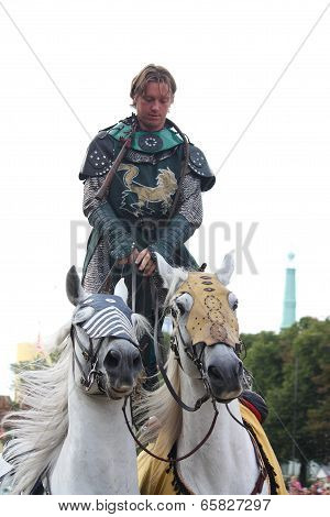 Riga, Latvia - August 21: Unidentified Man From The Devils Horsemen Stunt Team Riding Two White Hors