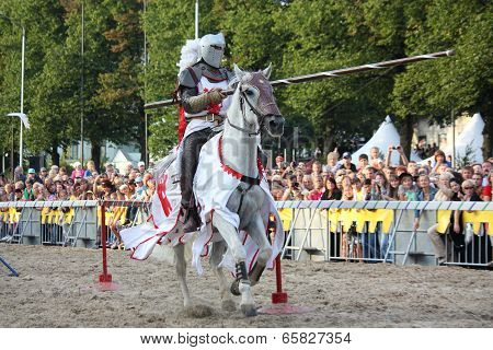 Riga, Latvia - August 21: Member Of The Devils Horsemen Stunt Team Riding White Horse During Riga Fe