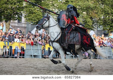 Riga, Latvia - August 21: Gerard Naprous From The Devils Horsemen Stunt Team Riding White Horse Duri