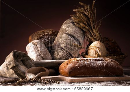 Fresh Bread And Wheat On The Wooden Table