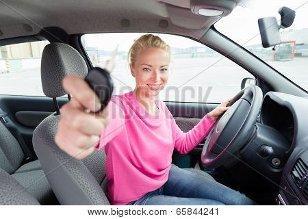 Woman driver showing car keys.