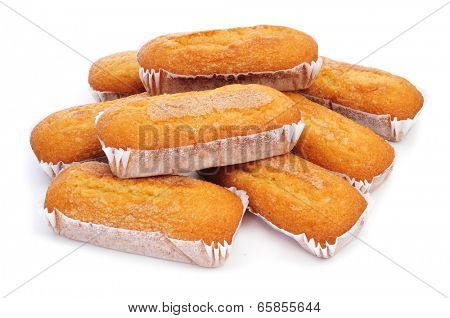 closeup of a pile of magdalenas largas, typical spanish plain muffins, on a white background