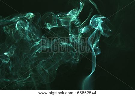 Green colored smoke on a black background.
