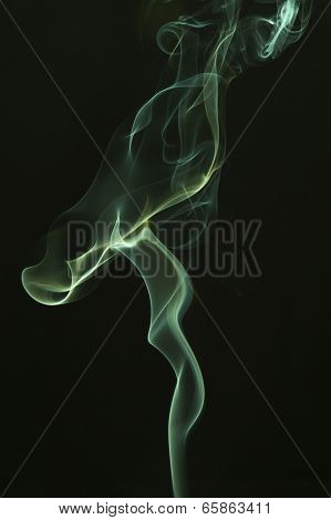 Green colored smoke on a black background.