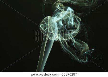Green colored smoke on a black background.
