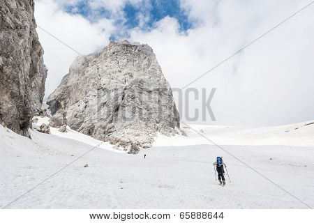 Skiiers Ascending Mountain Slope