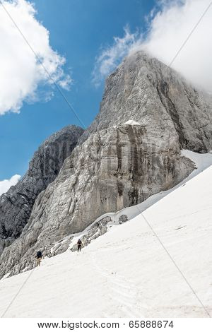 Mountain Peak With Descending Skiiers