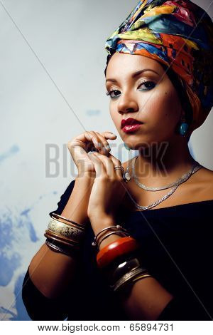 beauty bright african woman with creative make up, shawl on head like cubian woman