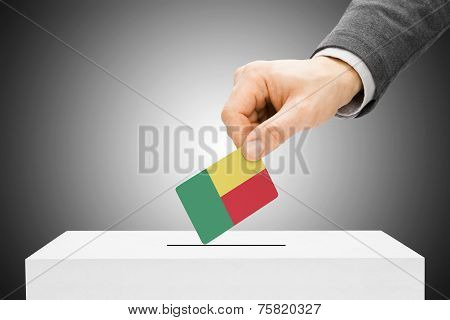 Voting Concept - Male Inserting Flag Into Ballot Box - Benin