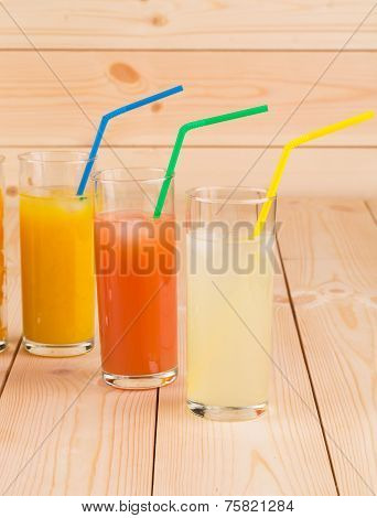 Lemonade orange and grapefruit juice on table.