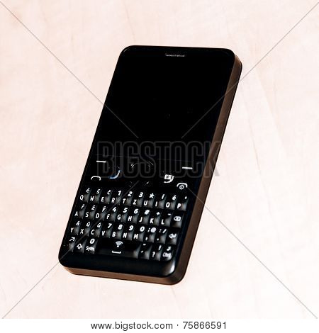 Black Smart Phone With Isolated Screen On Wooden Desk