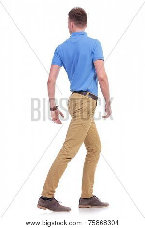 full length portrait of a young casual man turning away with his back towards the camera. isolated on a white background