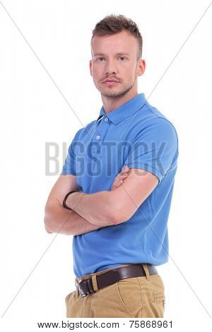 picture of a young casual man looking into the camera while holding his arms crossed. isolated on a white background