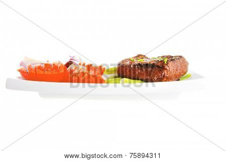 beef meat served with tomato on white porcelain