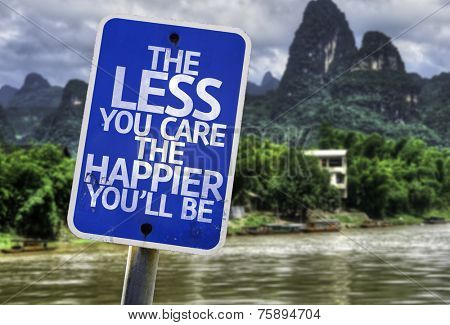 The Less You Care The Happier You'll Be sign with a forest background
