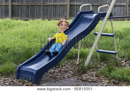 Balloon Person On A Blue Kid's Slide In The Back Yard