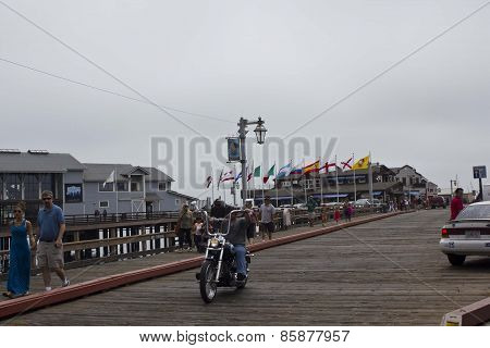 Grey Day In Santa Barbara, the pier with a moto and people walking