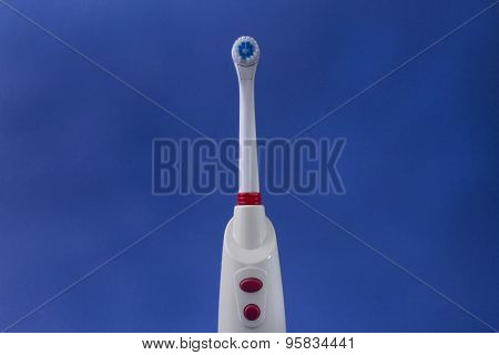 electric toothbrush with blue background