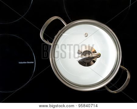 Stewpot on black induction cooker shot from above