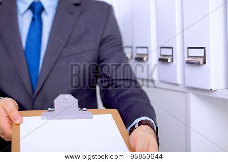 Businessman holding a blank white board