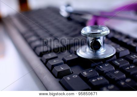 Violet stethoscope on a laptop computer