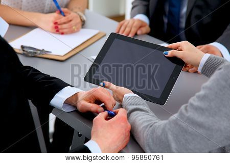 Business people sitting and discussing at business meeting, in office