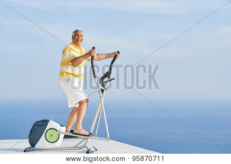 healthy senior man working out on gym treadmill machine at modern home terace with ocean view