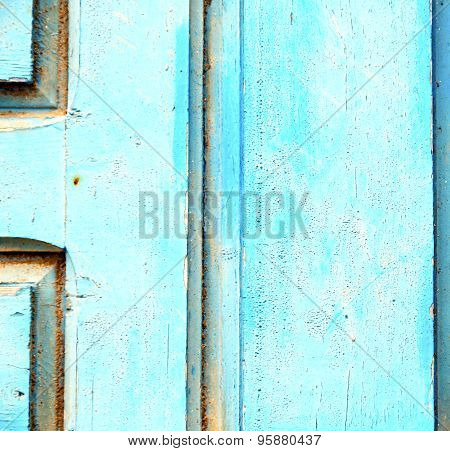 Stripped Paint In The Blue Wood Door And Rusty Nail