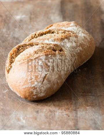 Artisan Brown Rye Bread On Wood Chopping Board