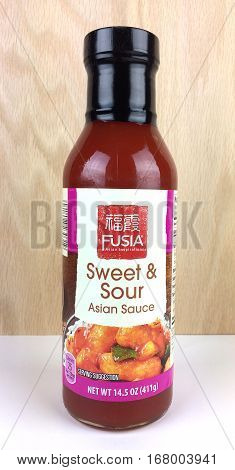 RIVER FALLS,WISCONSIN-FEBRUARY 02,2017: A bottle of Fusia brand Sweet and Sour sauce with a wood background.