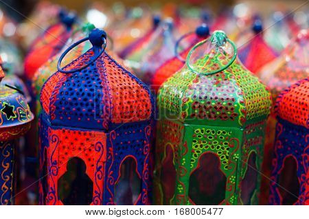 Lots of colorful handicraft metal lanterns painted in beautiful colors. This is a traditional art form of india and have been used to house religious lamps