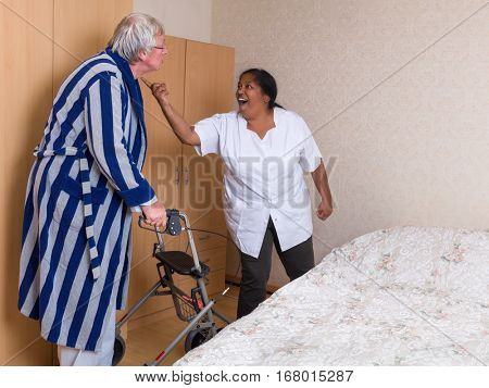 Funny scene of an elderly man having a discussion with his nurse