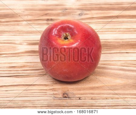 Ripe organic kanzi apple on vintage wooden tray