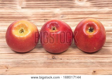 Ripe organic kanzi apple on vintage wooden tray