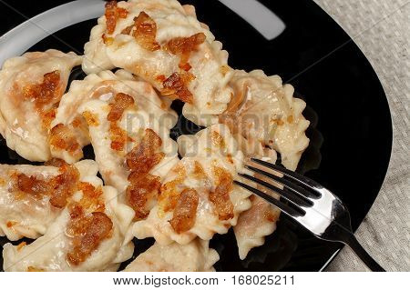 Traditional Ukrainian dumplings with bacon and cabbage.