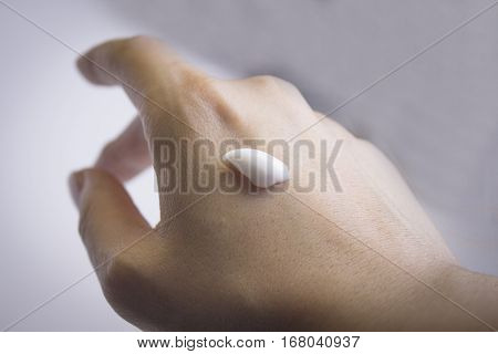 Hands of caucasian woman selfmassage with cream