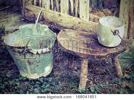 Old Broken Bucket And An Aluminum Pan