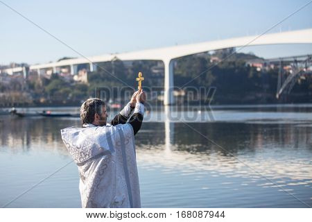 PORTO, PORTUGAL - JAN 19, 2017: Celebrating Baptism of Jesus and Epiphany bathing in Douro river in the Parish of Russian Orthodox Church. This is one of the holiest holidays for all Christians.