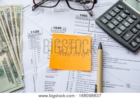 Tax form 1040 1120 1065 with pen calculator and sticker