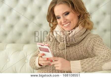 Portrait of a young beautiful woman using smartphone