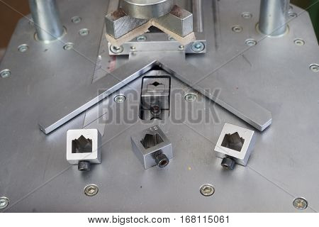 Craftsman working on frame in frameshop. Professional framer hand holding frame angle. Top view.
