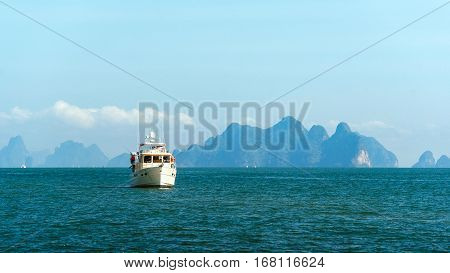 Lonely ship in the sea. The ship on a background of mountains