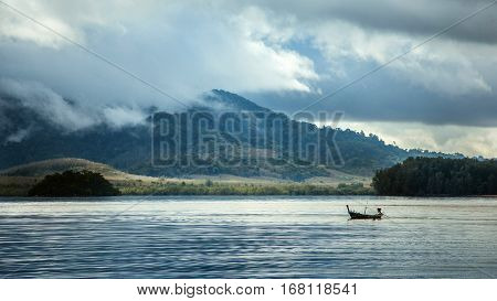 The rainy season in Asia. Boat on a background of mountains