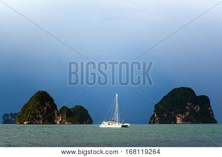 Yachts on the background of rocks. Yacht at sea
