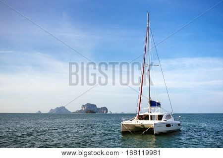 Yachts on the background of rocks. Yacht at sea
