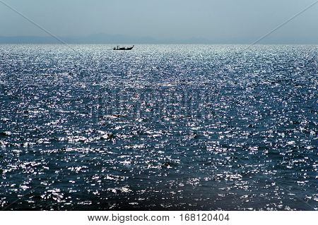 Thai boat on the horizon. A small boat in the vast ocean