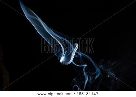 A blue knife formed by smoke from insence.