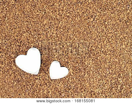 two mini heart shaped cookie cutter with white space on brown instant coffee powder, preparing romantic food and beverage, abstract love symbol texture background, close up top view with copy space