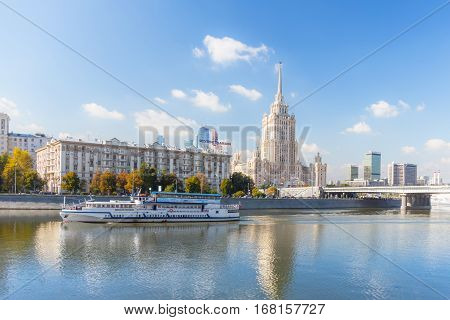 MOSCOW - SEPTEMBER 15 2015: Radisson Royal Hotel (Hotel Ukraina) with pleasure boat on the foreground.